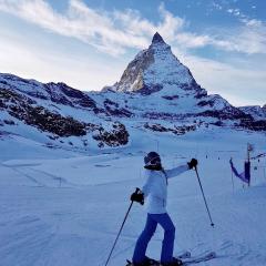 Student in the Swiss alps skiing. 